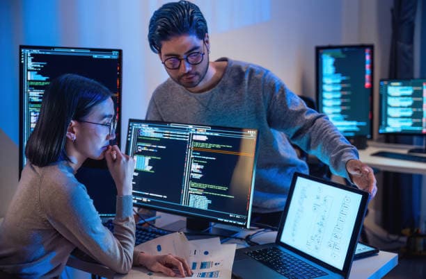 Software developers reviewing a digital workflow together